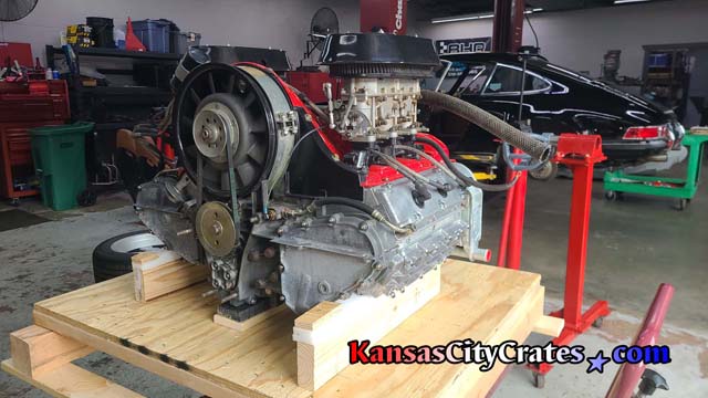 Boxster engine sitting on high density foam rails to cradle motor inside wood crate.