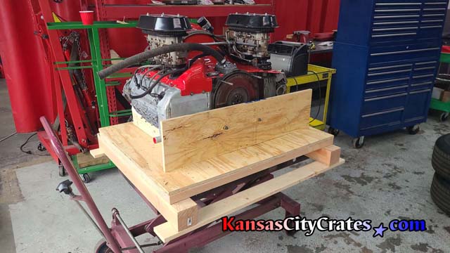Engine is bolted to support blocks to secure it inside wood crate.