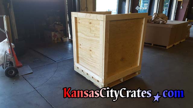 Assembled side view of industrial heavy duty vault crate with forklift base