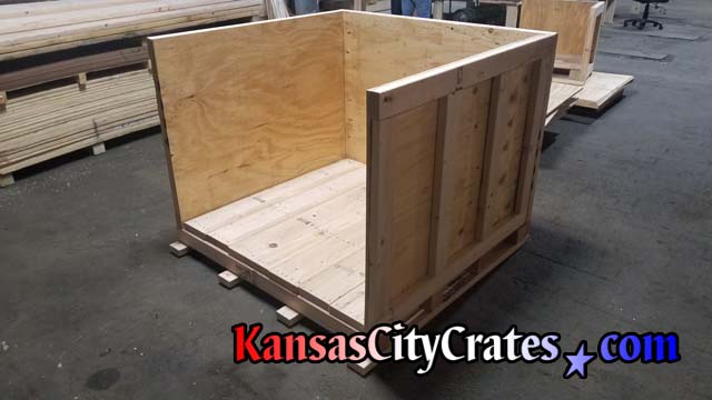 Crate builders check vault crate before steel banding onto pallet for delivery