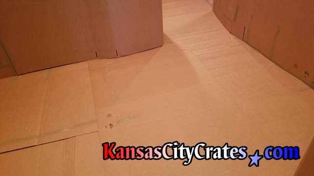 Heavy cardboard protects hardwood floor in condo on the Country Club Plaza