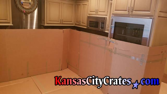 large cardboard protects the interior walls of condo during crate service