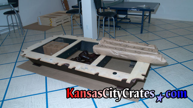 After billiard table is disassembled, all parts are left on cardboard to protect the floor.