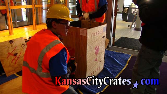 Kansas City Crates Safety Director assists packing of crate with championship trophy