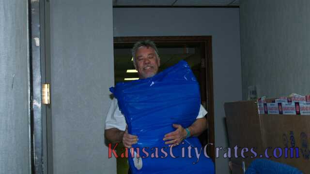 John McLaughlin carrying packing paper