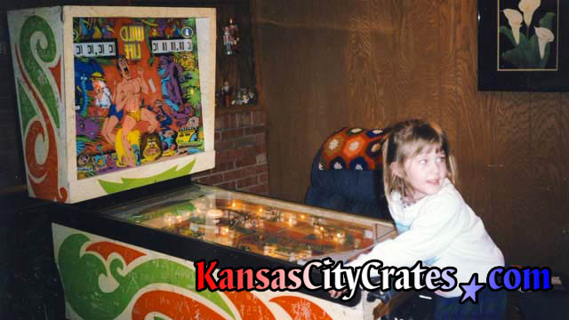 Little girl playing 1967 Wild Life pinball machine by D. Gottlieb and Co.