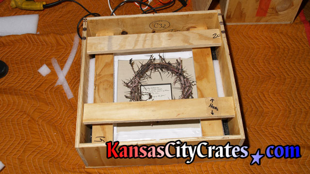 Open view of crate to show rigging to protect delicate thorns during transport.