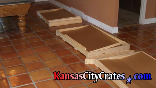 3 crates lined up for loading of slate once removed from billiard table base.