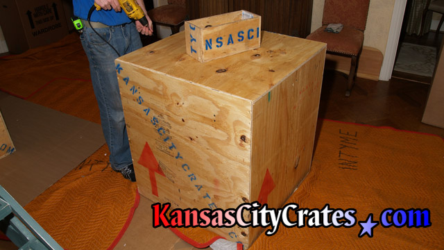 Solid wall export crate containing chandelier on flooring protection at home in Lexington MO 64067