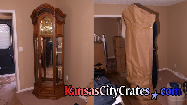 3 sided glass longcase clock from the black forest germany getting wrapped for crating.