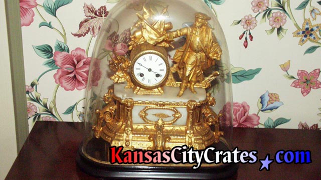 Mantle spring wound clock made of gold leaf and marble under glass before packing.