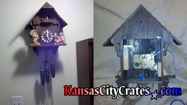 Cuckoo clock removed from wall laying on paper with back removed to access bellows, dancing platform gear and figures for service before packing into export crate at home in Leavenworth KS  66048