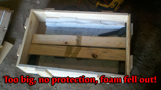 Marble top laying bare in wood crate with no protection.