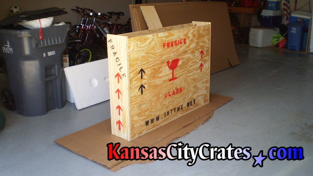 Wood crate resting on cardboard in garage.