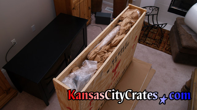 Crate company packing television.