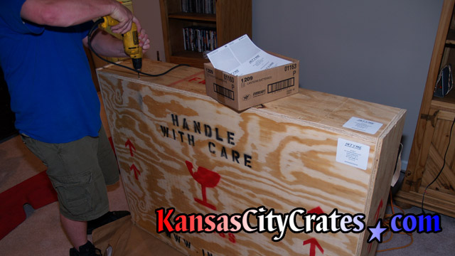 Crates are marked with shipping symbols for handlers.