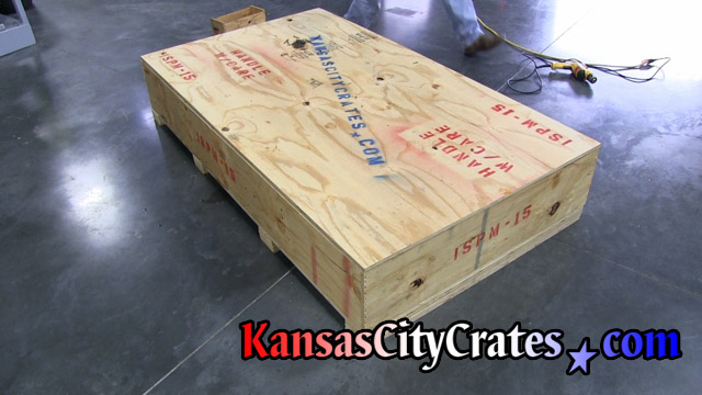 Crate with injection molding piece inside resting on cushioning.