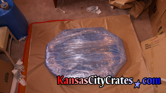Mirror wrapped in paper, bubble and stretch wrap before placing into wood vault like crate.