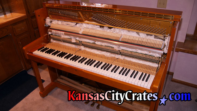Packing the soundboard of fine Sauter Upright piano before crating.