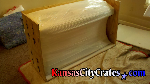 Paper, bubble, stretch wrapped digital piano in export crate for international shipping.