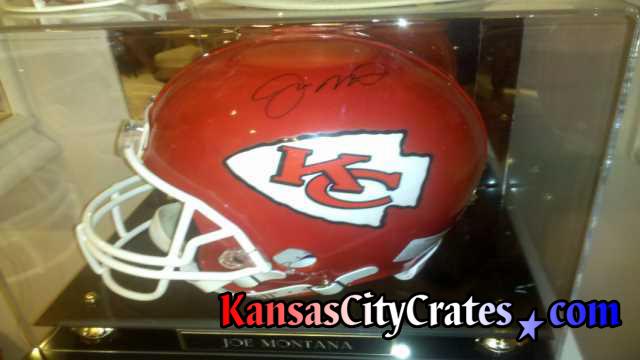 Autographed helmet in glass case before wrapping and shipping in wooden box crate.