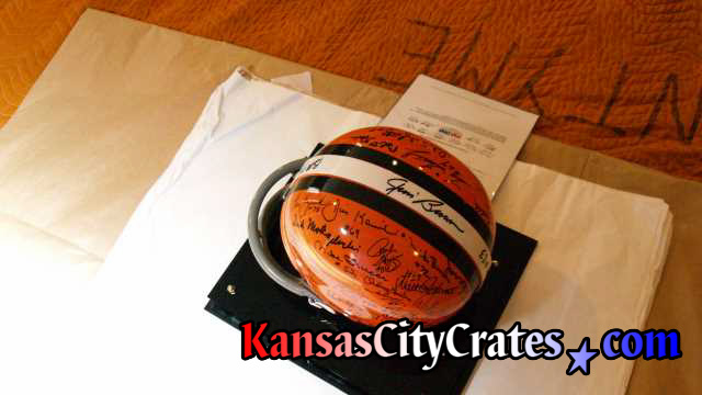 Football helemt on acid free paper with Certificate of Authenticity being wrapped for packing into wood crate.