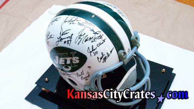 Superbowl III winners showing Joe Namath's autograph on paper for packing into export crate.