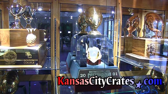 Glass cabinet with large trophies on display at Football Complex