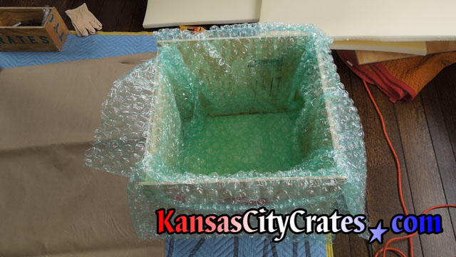 Additional layers of bubble wrap are placed in foam cushioned solid wall wooden crate to protect Robin's nest antique vase