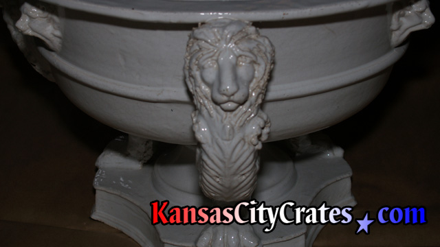 Front view of lions head pedestal on antique serving bowl