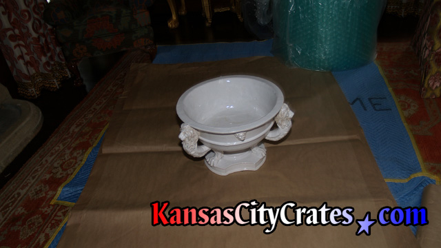 Antique collectors serving bowl on paper getting wrapped before packing into solid wall crate for storage during rennovations at mansion in Mission Hills KS