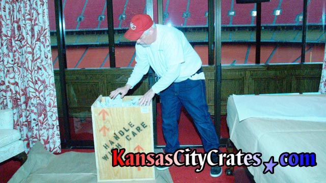 Packing wood crate in suite at Arrowhead Stadium in Kansas City during stadium rennovations.