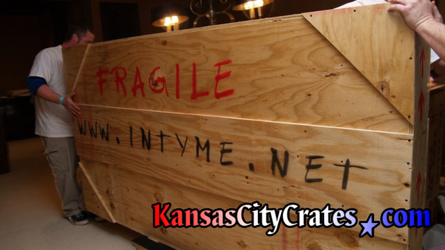 Moving wooden crate on cart at home in Kansas City MO