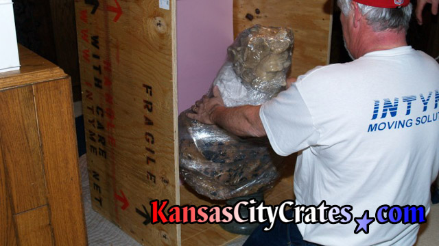 Packing bust sculpture into indestructible box crate.