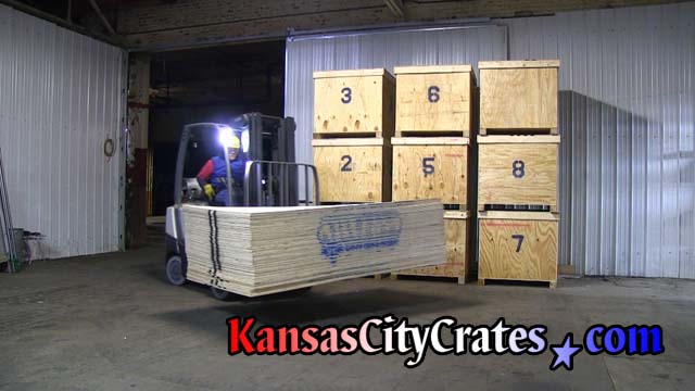 Crown C5 Forklift unloads a unit of plywood lumber used for crate production