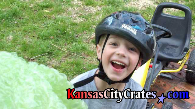 Excited child jumping off his bicycle to get the bubble wrap we gave him at his grandparents house.